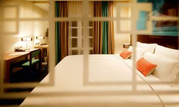 a large white bed sitting in a room