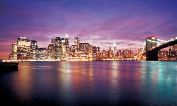 a large body of water with a city in the background