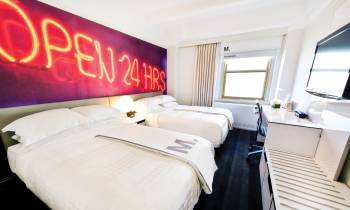 a bedroom with a large bed in a hotel room