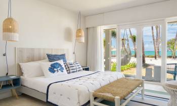 a bedroom with a bed and a chair in a room
