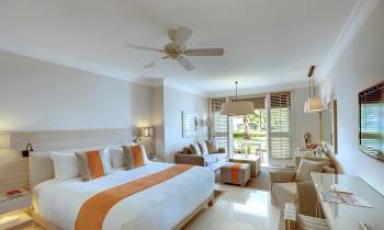 a bedroom with a bed and a table in a room