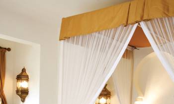 a bedroom with a bed and a mirror