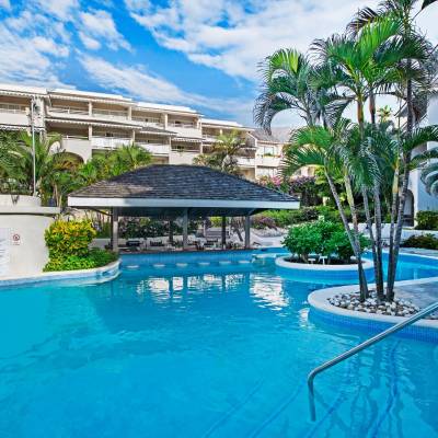 a house with a pool in front of a building
