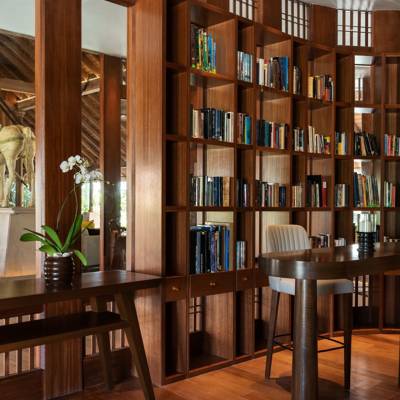a dining room table in front of a book shelf
