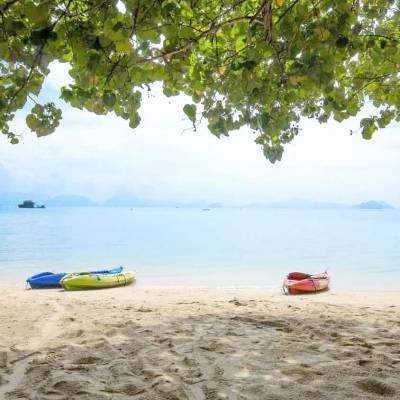a boat sitting on top of a sandy beach