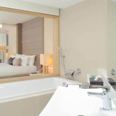 a large white tub next to a sink