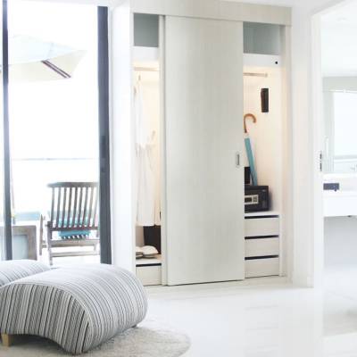a bedroom with a bed and a chair in a room