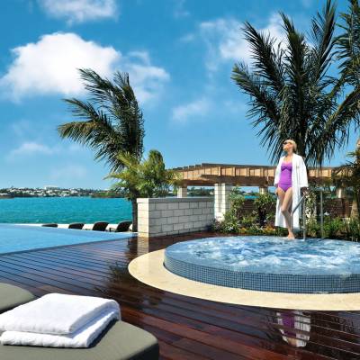 a large pool of water in front of a palm tree
