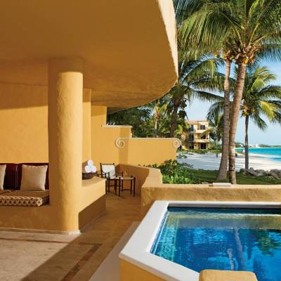 a pool next to a palm tree on a table