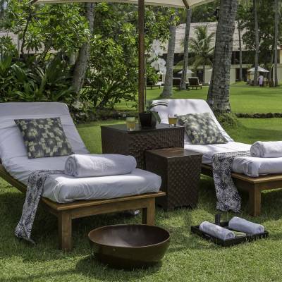 a couple of lawn chairs sitting on top of a grass covered field