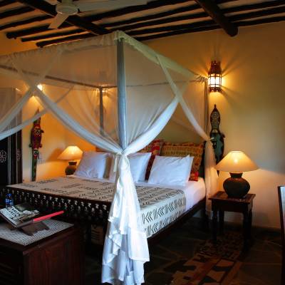 a bedroom with a bed and desk in a room