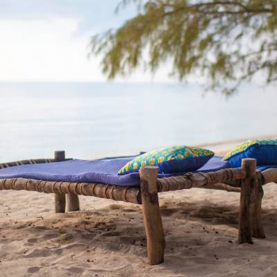 a wooden bench sitting next to a body of water