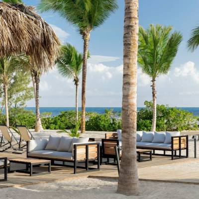 a group of lawn chairs sitting on top of a sandy beach