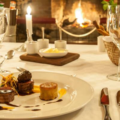 a plate of food and glasses of wine on a table