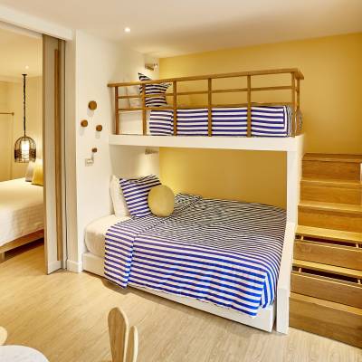 a bedroom with a bed and a mirror in a room