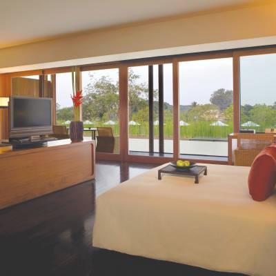 a bedroom with a bed and desk in a hotel room