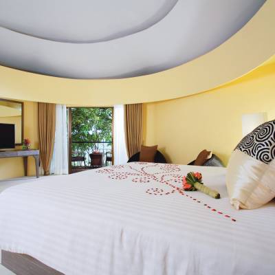a large white bed in a hotel room
