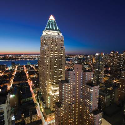 a large clock tower towering over a city at night