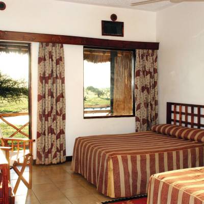 a bedroom with a bed and a chair in a room