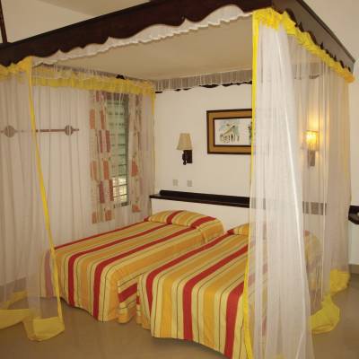 a bedroom with a bed and desk in a room