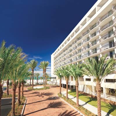 a large building with palm trees