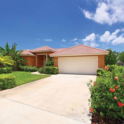 a close up of a flower garden in front of a house