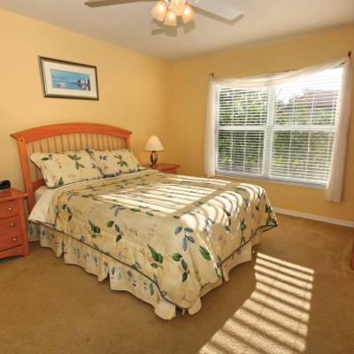 a bedroom with a bed and desk in a small room