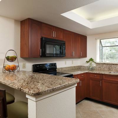 a modern kitchen with stainless steel appliances and wooden cabinets