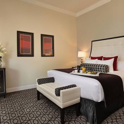 a bedroom with a bed and desk in a room