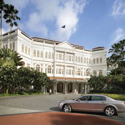 a car parked in front of Raffles Hotel
