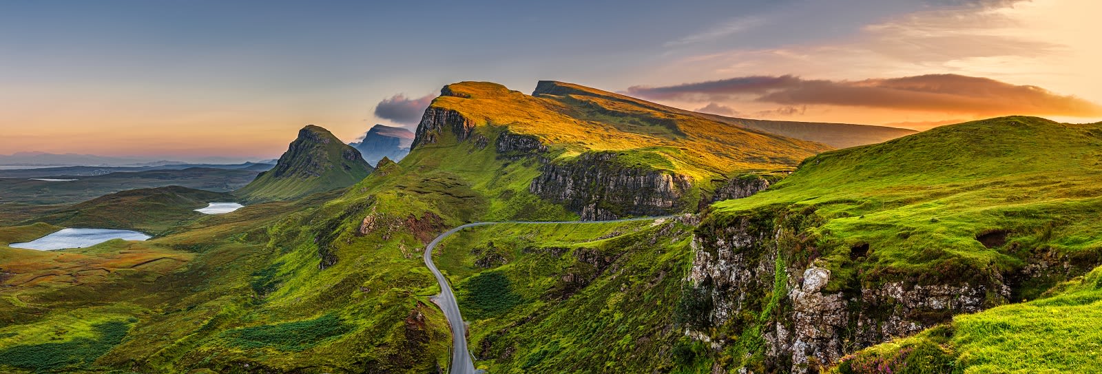 Panorama of Quiraing mountains sunset at Isle of Skye, Scottish highlands, United Kingdom Panorama of Quiraing mountains sunset at Isle of Skye, Scottish highlands, United Kingdom