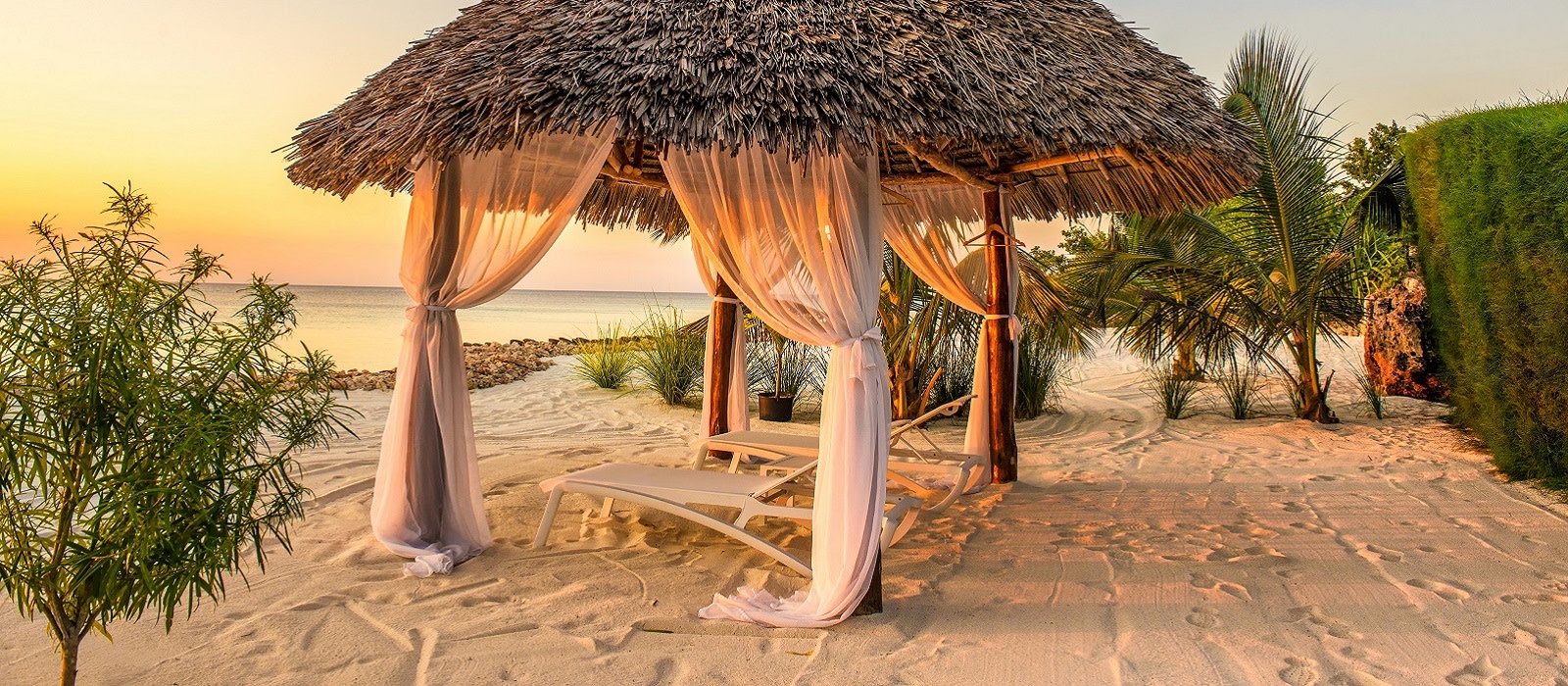 Beach lounge chairs at sunset at the shore of Indian ocean, Zanzibar, Tanzania, Africa Enchanting Travels Beach lounge chairs at sunset at the shore of Indian ocean, Zanzibar, Tanzania, Africa Enchanting Travels