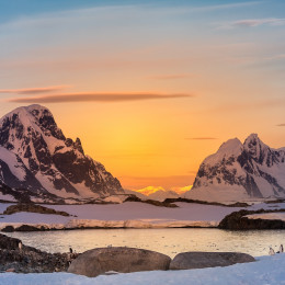 Enchanting Travels Antarctica Tours Beautiful snow-capped mountains against the sunset sky in Antarctica