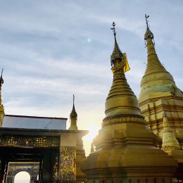 Myanmar_Golden pagodas on top of Mandalay Hill with sun setting in the background