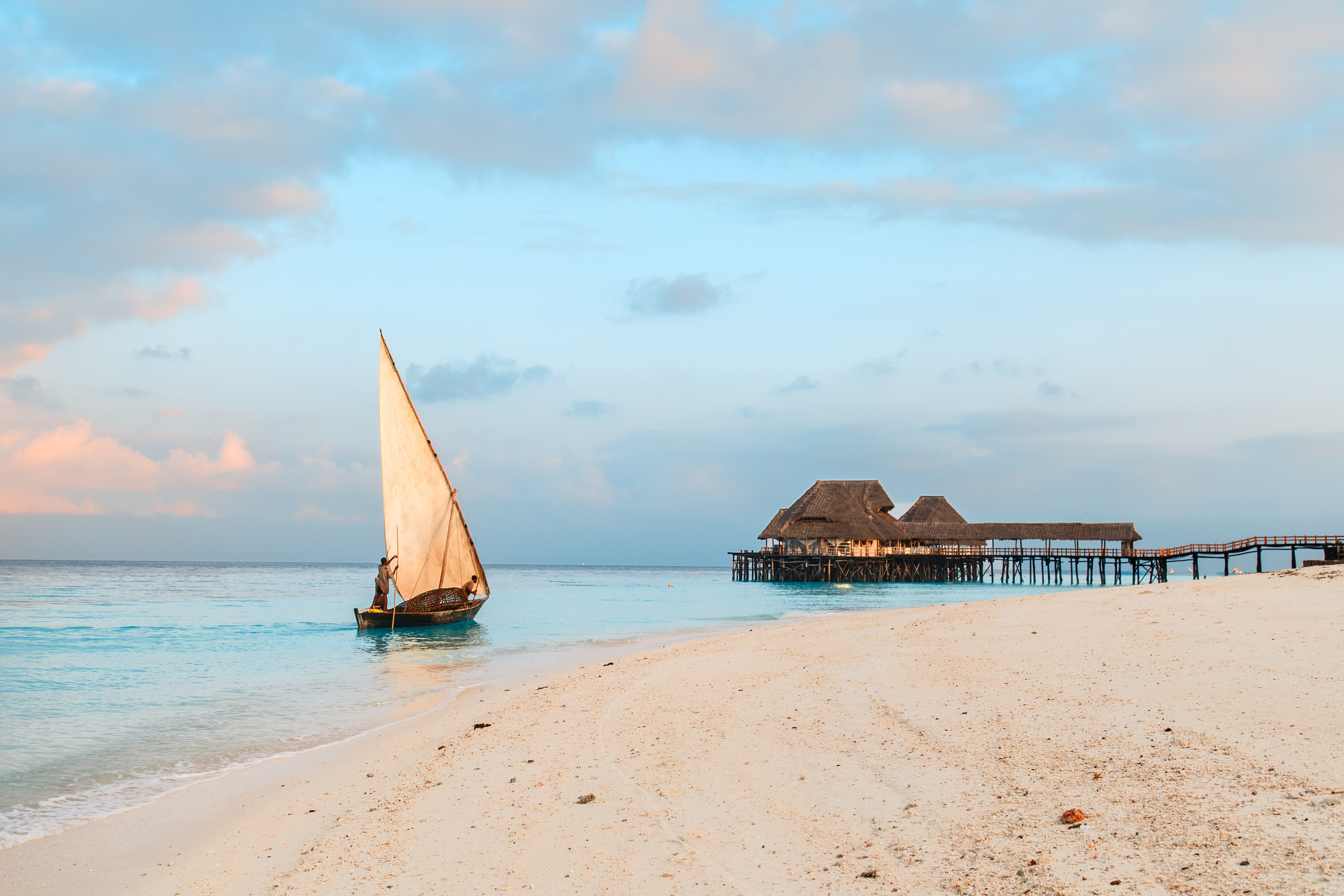 Beautiful sunrise over ocean with fishing boat, fishermen, hut, Nungwi, Kendwa, Zanzibar island, Tanzania Africa Zanzibar
