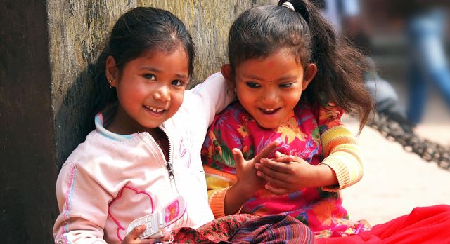 Kids sitting on the street of Kathmandu Enchanting Travels Nepal Tours