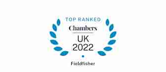 The image shows an award badge with a blue laurel wreath design. Text reads "Top Ranked Chambers UK 2022" with "Fieldfisher" written below.