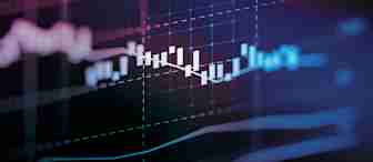 A close-up of a digital screen displaying a financial chart with candlestick patterns, grid lines, and various data lines. The background is dark, illuminated by colorful lights and gradients, creating a dynamic and futuristic feel.