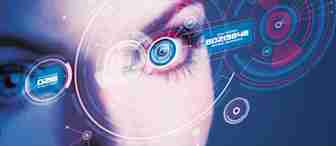 Close-up of a person's eye surrounded by futuristic digital interfaces and holographic elements in blue and red. The interfaces display various codes and data, suggesting advanced technology, such as biometric scanning or augmented reality.