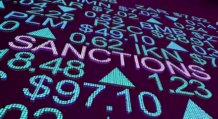 A digital display shows various currency symbols, numbers, and the words "SANCTIONS" prominently in the center. The background is a deep purple, with blue and green elements highlighting the text and symbols, suggesting a financial or economic theme.