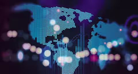 A stylized, digital representation of a world map using blue dots against a dark purple background. Bokeh light effects with various colors overlay parts of the map, adding a sense of depth and dynamic movement.