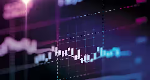 A close-up of a digital screen displaying a financial chart with candlestick patterns, grid lines, and various data lines. The background is dark, illuminated by colorful lights and gradients, creating a dynamic and futuristic feel.