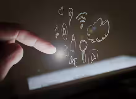 A finger is about to touch a glowing tablet screen, with various hand-drawn icons floating above the screen. The icons include a heart, a location pin, WiFi symbol, cloud, music note, bell, envelope, thumbs-up, and play button. The background is dark.
