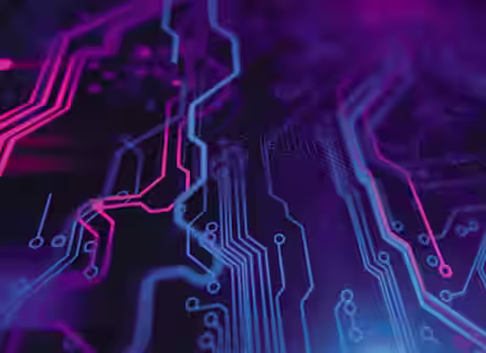 A close-up view of a circuit board with intricate patterns and connections, illuminated with neon pink and blue lights, creating a futuristic and high-tech atmosphere. The colors blend and intertwine, highlighting the detailed pathways on the board.