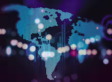 A stylized, digital representation of a world map using blue dots against a dark purple background. Bokeh light effects with various colors overlay parts of the map, adding a sense of depth and dynamic movement.