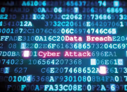 A screen filled with rows of random numbers and letters in blue, representing code. In the center, the words "Data Breach" and "Cyber Attack" are highlighted in red, standing out among the blue code. The image conveys themes related to cybersecurity threats.