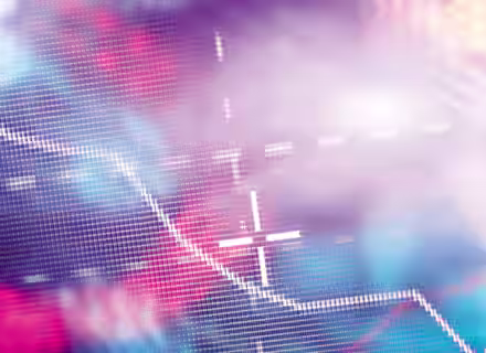 A vibrant, abstract image depicting a downward-trending graph against a colorful, blurred background with soft pink, blue, and purple hues. The graph is created with small, square pixels and includes intersecting white crosshairs near its center.