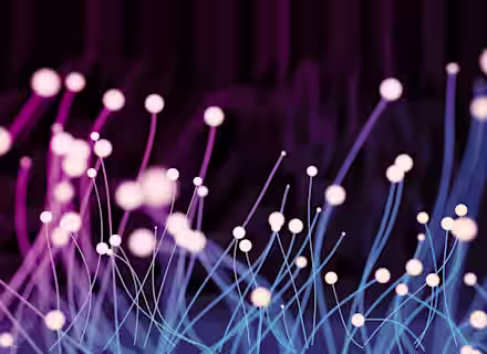 A digital illustration featuring abstract lines and glowing dots, reminiscent of light trails or neural networks. The colors transition from pink to purple and blue, creating a dynamic and futuristic aesthetic against a dark background.