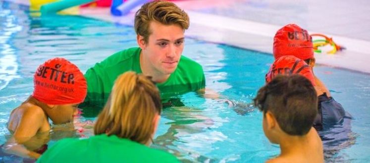 Swim teacher teaching children how to swim at Vauxhall leisure centre