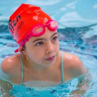 girl in water wearing red Better branded swimming cap